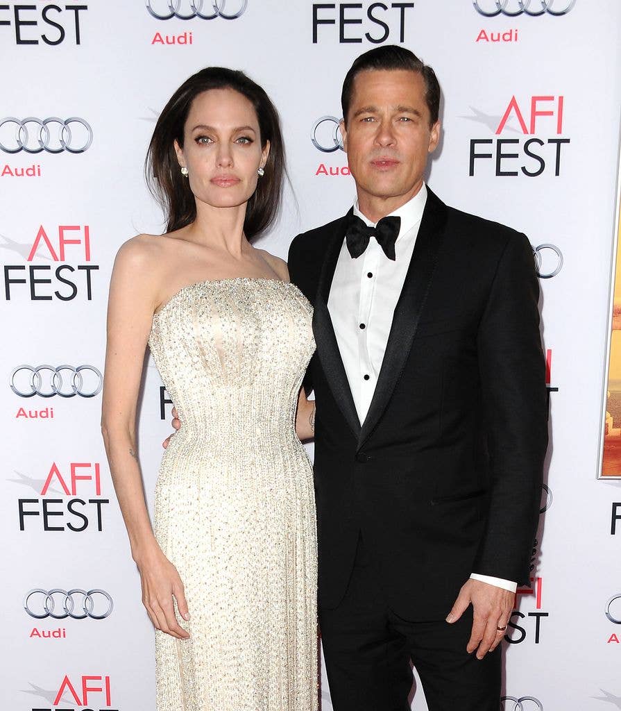 Brad and Angelina posing for a photo at a red carpet event