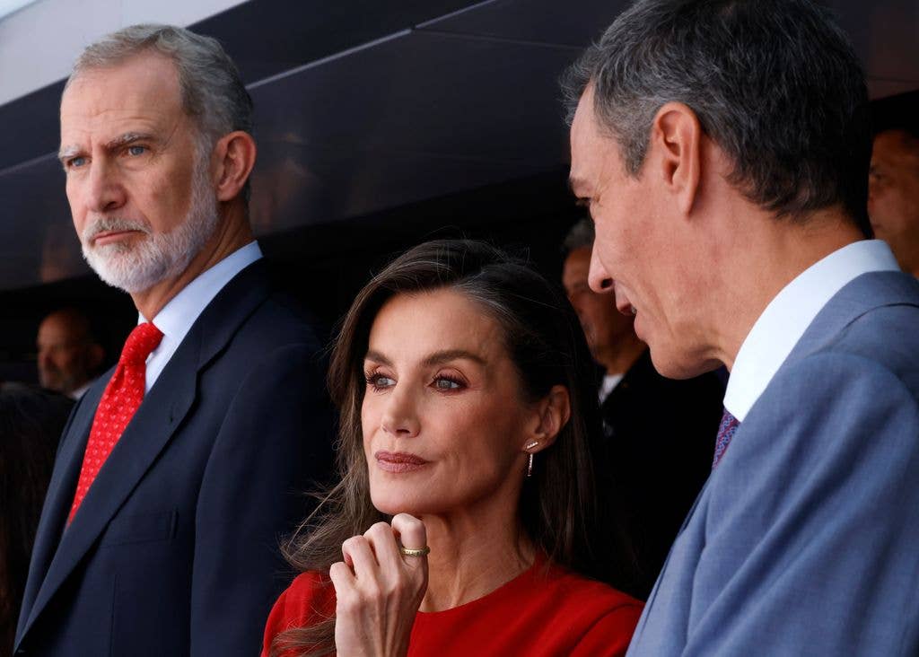 Queen Letizia of Spain in red with her hand on her chin