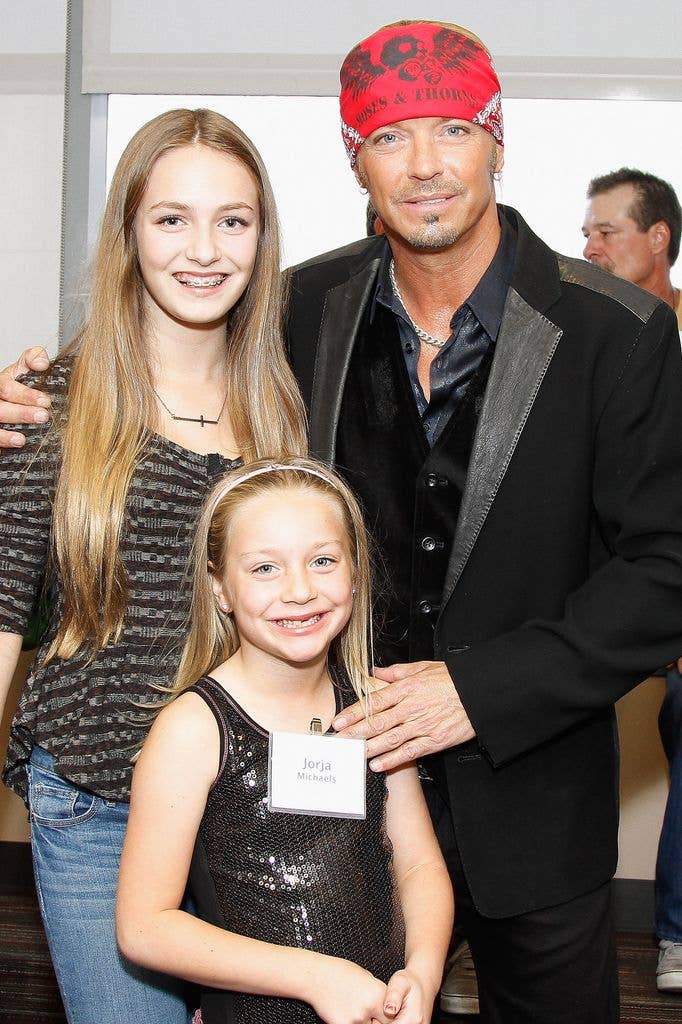 Musician Bret Michaels poses with daughters  Raine Sychak (L) and Jorja Sychak (C) during the ribbon cutting ceremony for the new Bret Michael's Hospitality and Music Room at St. Joseph's Barrow Neurological Institute on October 9, 2012 in Phoenix, Arizona