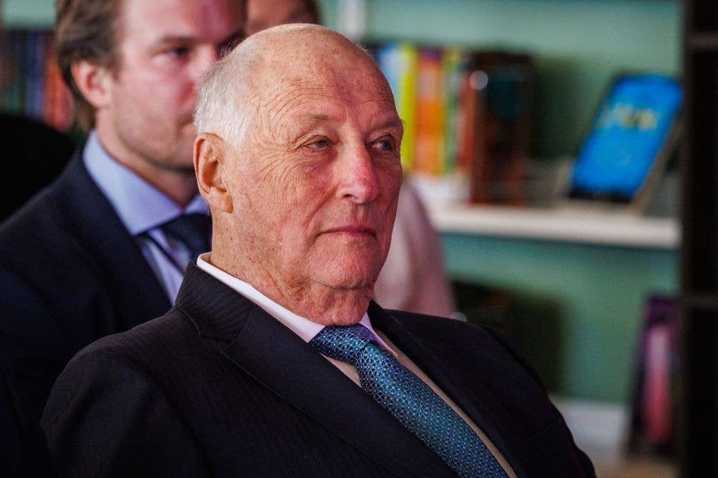 King Harald sitting in a chair while looking serious