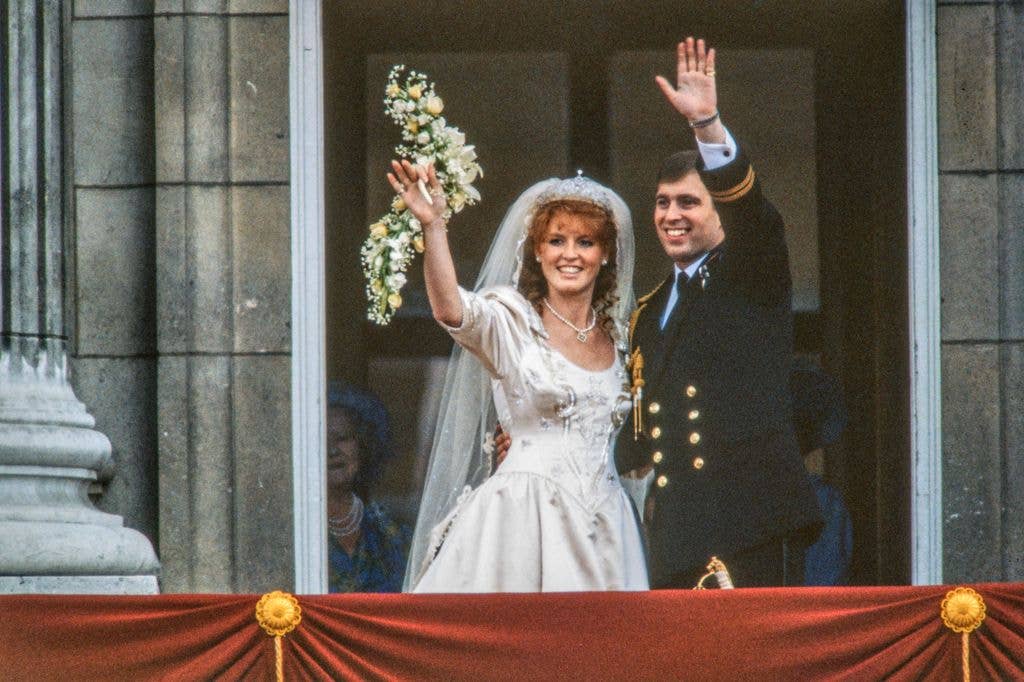 View of just-married couple Sarah, Duchess of York, and Prince Andrew, Duke of York, as they wave from the balcony of Buckingham Palace, London