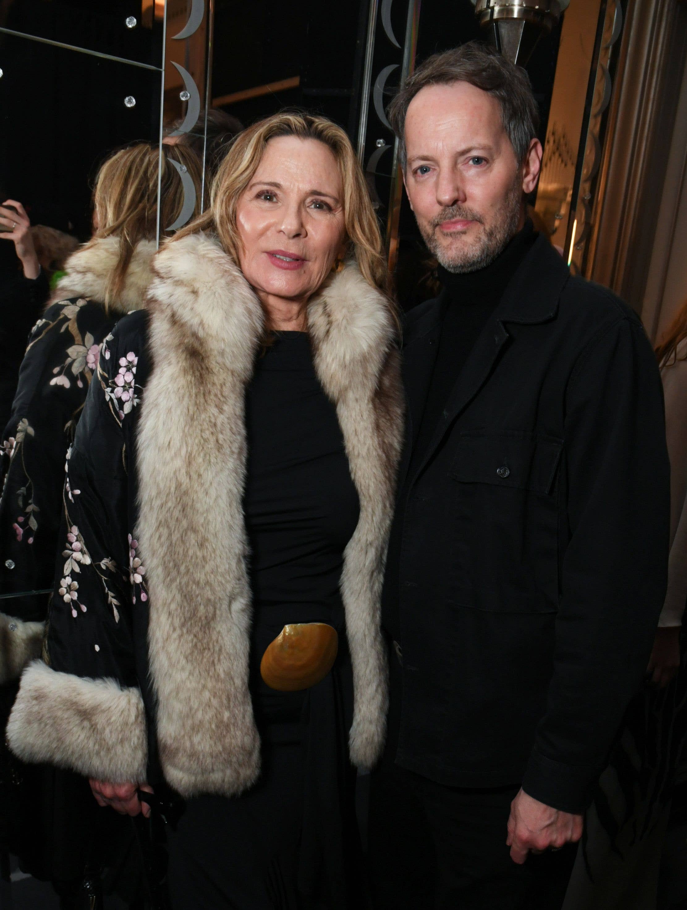 Kim Cattrall (L) and Russell Thomas pose backstage at the Conner Ives show