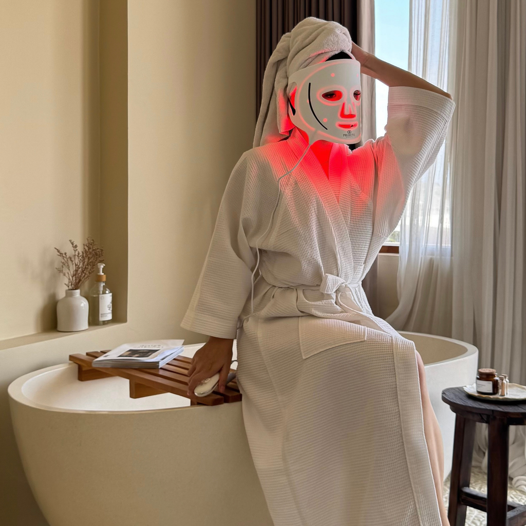 woman wearing LED face mask before bath