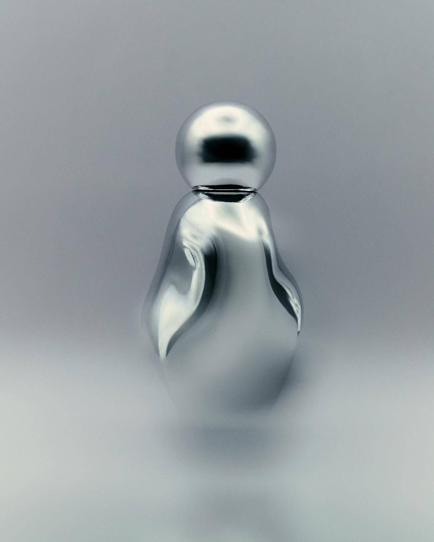 Silver perfume bottle on a grey background