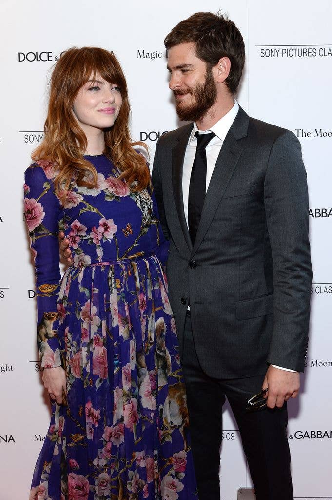 Emma Stone in a floral dress and Andrew Garfield in a grey suit
