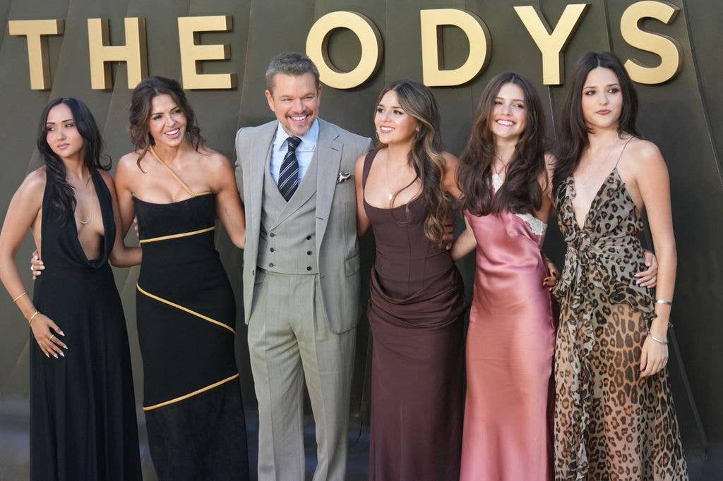 Matt and Luciana pose with their daughters on the red carpet as they arrive to attend the world premiere of the film 'The Odyssey' 