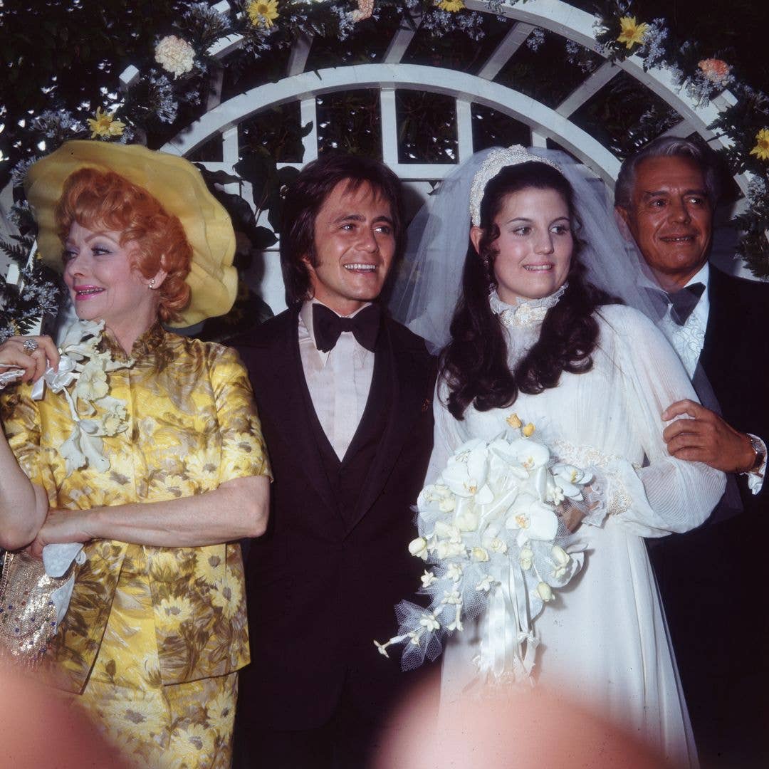 1971:  American actors and comedians Lucille Ball (1911 - 1989) and her former husband, Cuban-born actor and bandleader Desi Arnaz (1917 - 1986), pose with their daughter, Lucie Arnaz, and her bridegroom, Phil Vandervort.