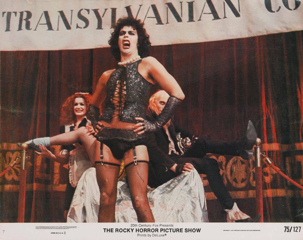 From right to left, actors Richard O'Brien, Tim Curry and Patricia Quinn as Riff Raff, Dr Frank-N-Furter and Magenta respectively, on a lobby card from the 1975 musical comedy 'The Rocky Horror Picture Show