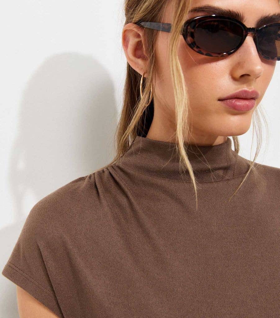 Close up of model in new look brown high neck top