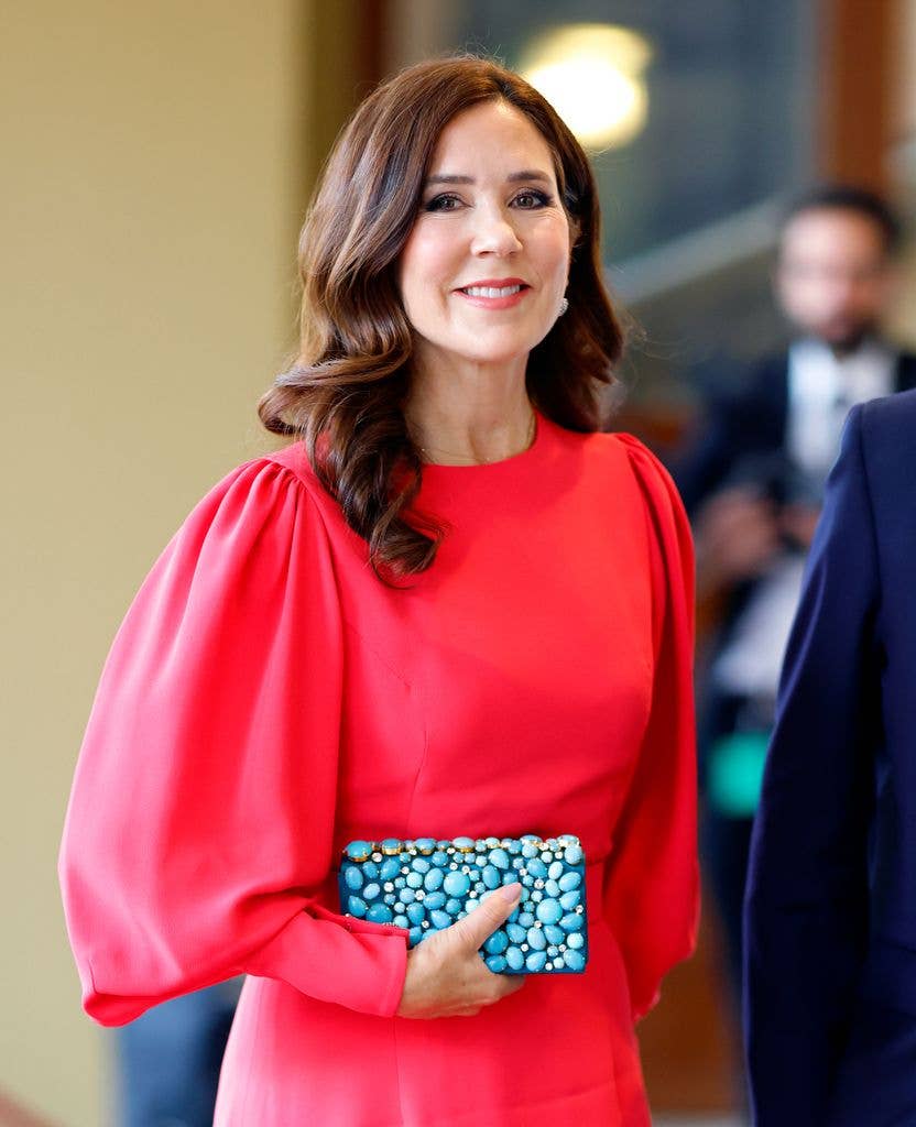 Crown Princess Mary of Denmark smiling and wearing a red dress