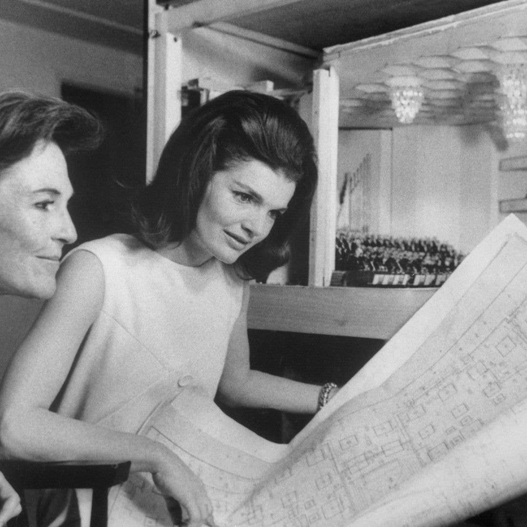Examine Model of Kennedy Center; Mrs. Jacqueline Kennedy (right) and Mrs. Joan Braden examine a model of the Kennedy Center for the Performing Arts in the office of architect Edward Durrel Stone, April 2nd. The Center will be built in Washington. Mrs. Braden's husband is running fot Lt. Gov. of California.