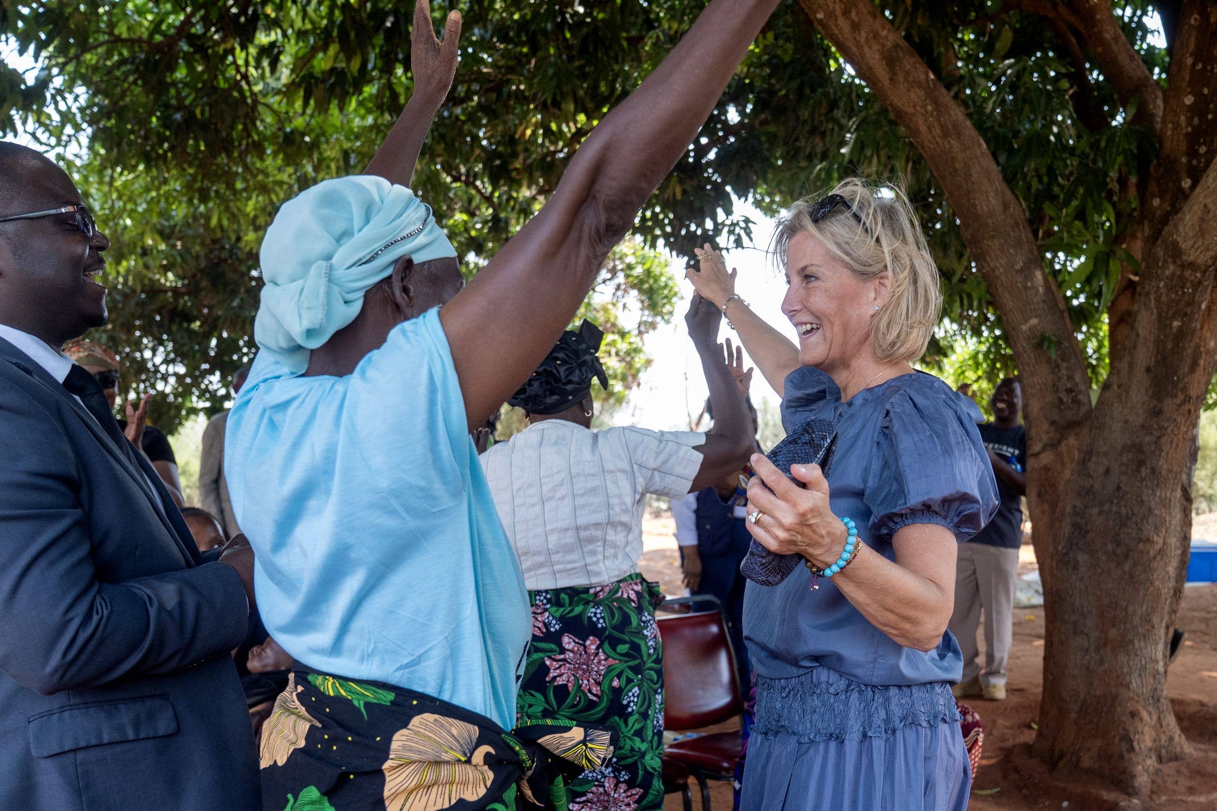 The Duchess of Edinburgh dances with one of the eye clinic patients during her visit to Mukuni Rural Health Centre in Livingstone to recognise Zambia's progress to eliminate trachoma, a painful and potentially blinding eye disease