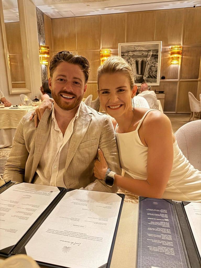 Elizabeth Smart and her husband cozy up looking happy and smiling in a restaurant 