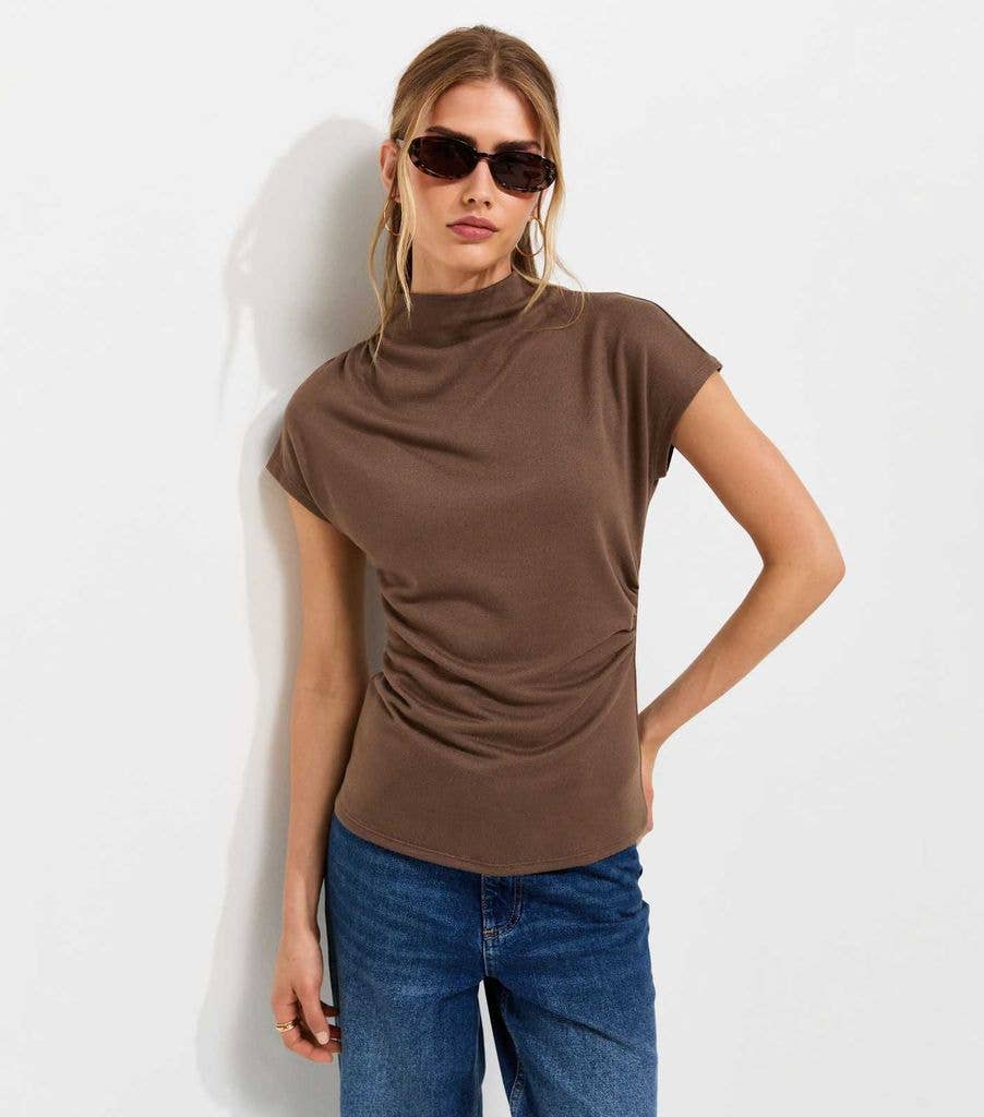 woman in brown new look high neck top 