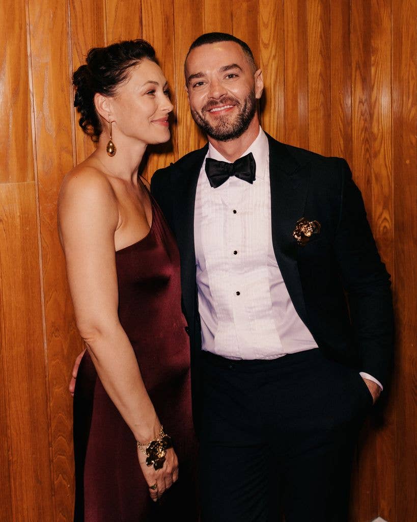 Emma Willis and Matt Willis smiling, dressed in formal attire, standing close together.