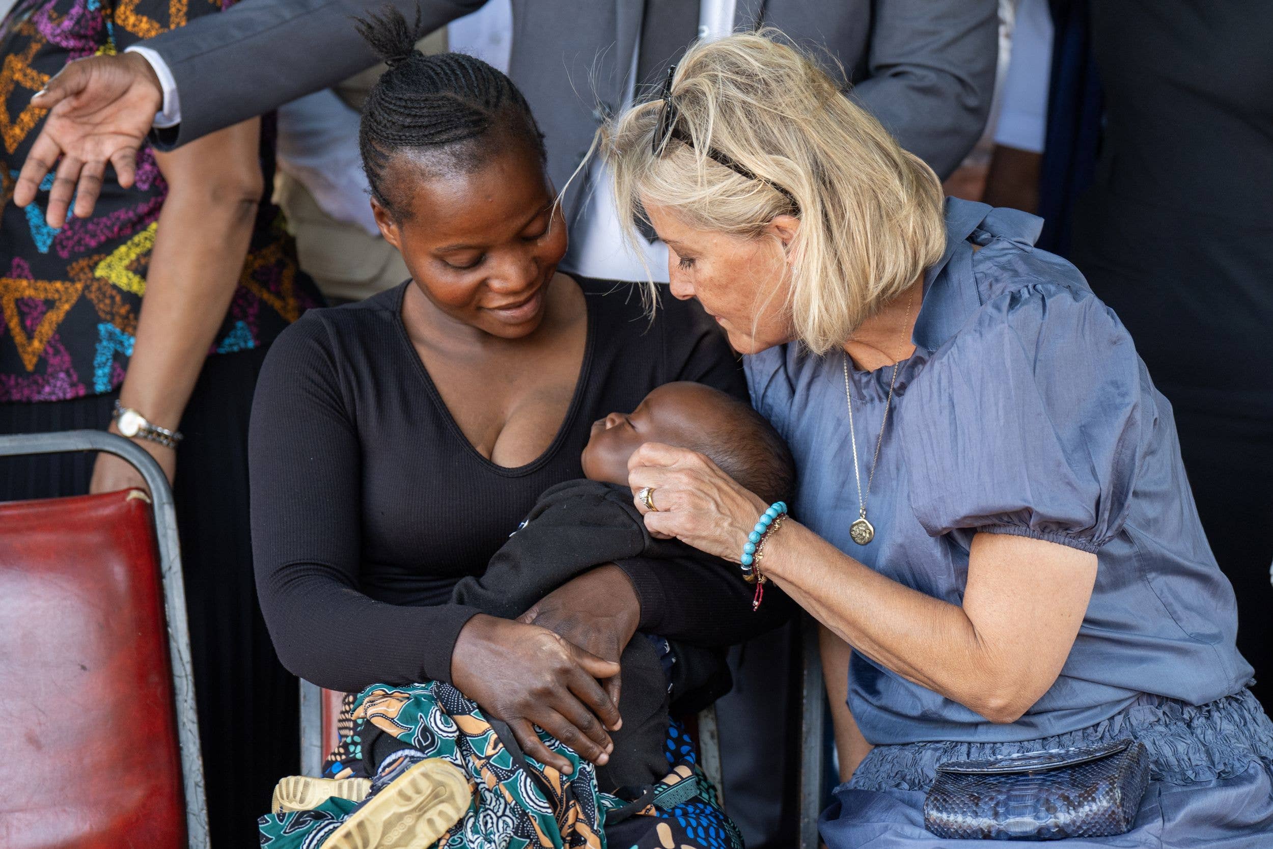 The Duchess of Edinburgh sits alongside Priscah Mwanaseluka and her six-month old baby after hearing about the mother's recovery from a disease that would have blinded her
