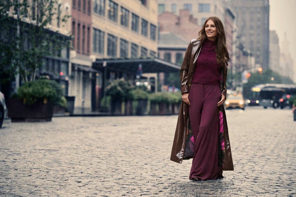 Elizabeth Hurlet walking down cobble street in new york