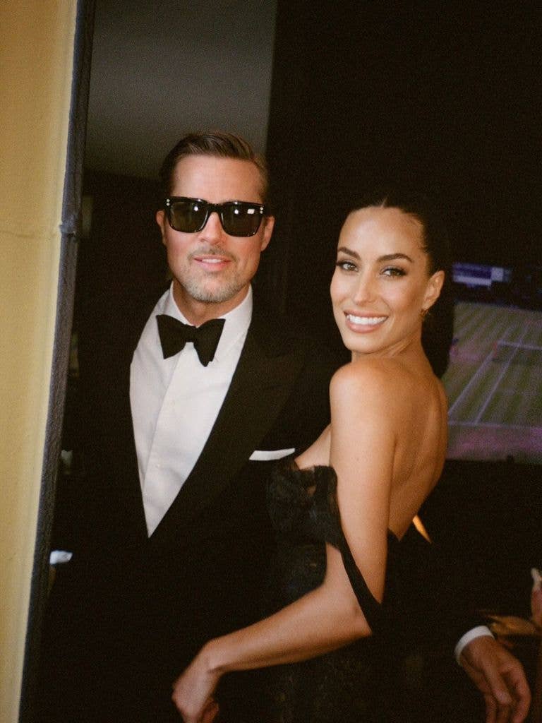 Brad and Ines ahead of Taylor Swift's wedding looking glam in a black dress and Brad wearing a tuxedo ad dark sunglasses