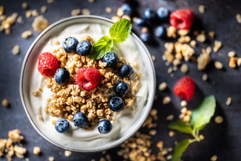 Yogurt bowl with muesli, raspberries and blueberries. A healthy breakfast or snack, rich in protein, fiber and calcium