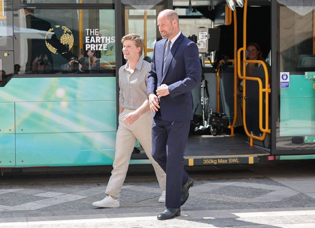 Prince William smiles as he arrives with Robert Irwin by bus to the Earthshot Prize Impact Assembly for Climate Action Week