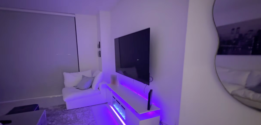 Kai's living room has a luxe fireplace