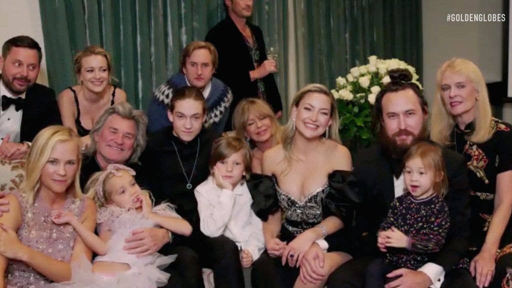 Group photo of Goldie Hawn, Kurt Russell, Kate Hudson, and other family members at a festive gathering.