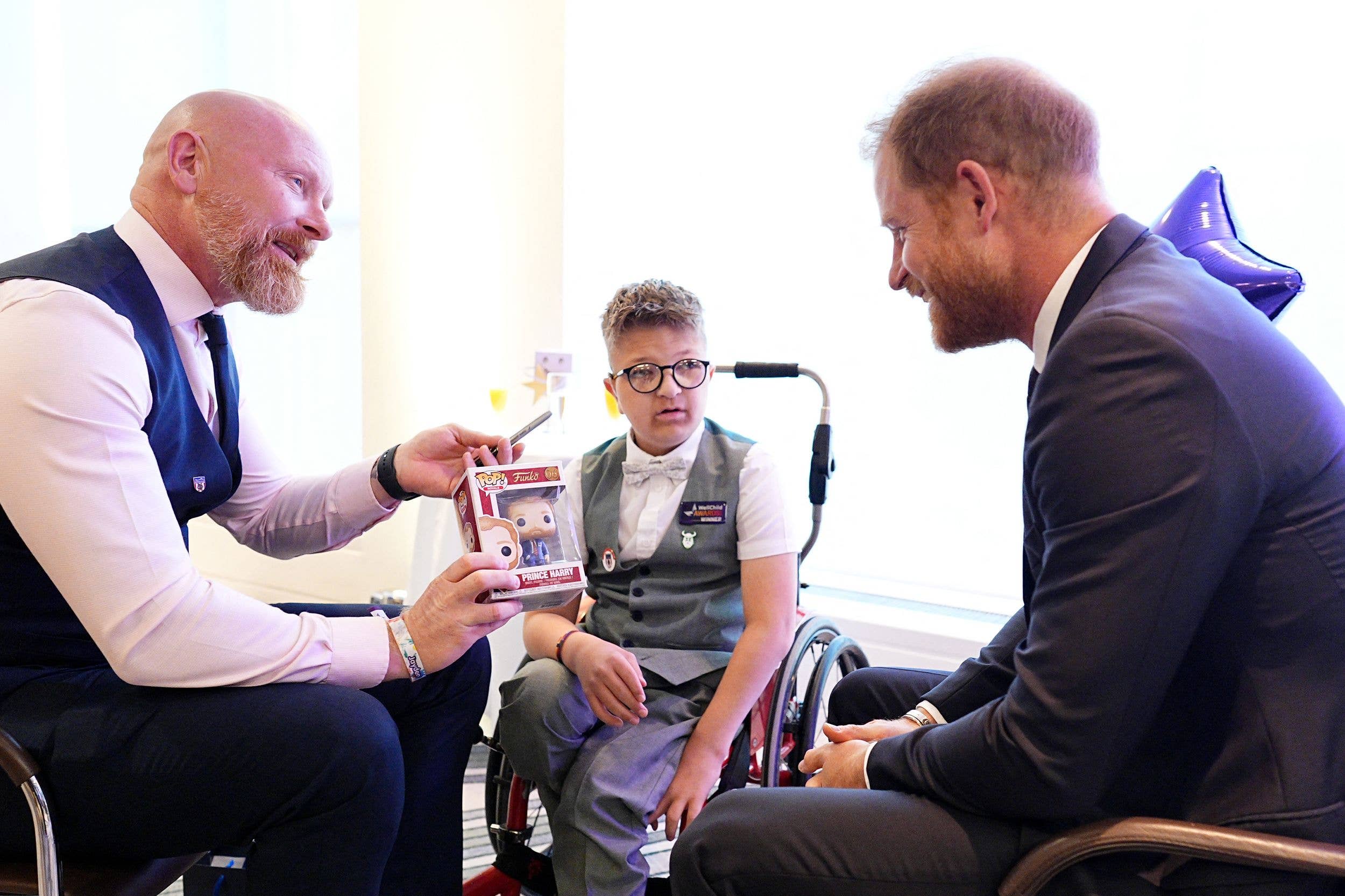 Prince Harry, Duke of Sussex (R) meets with winner of the Inspirational Child 7-11, Will Messer (C) and his father during the annual WellChild Awards at the Royal Lancaster Hotel in London on September 21, 2026.
