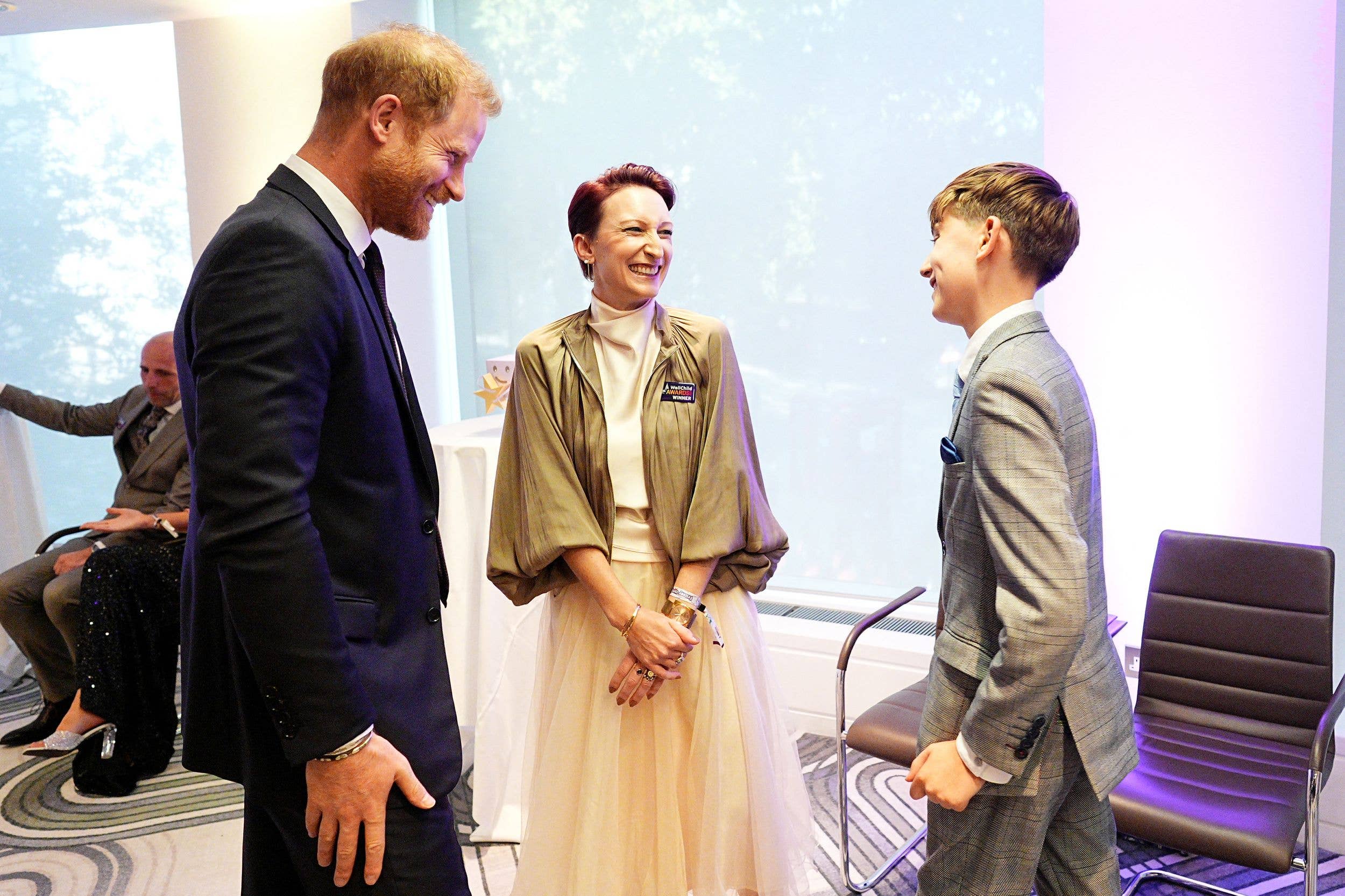 Prince Harry, Duke of Sussex (L) meets with the winner of the Champion of Children's Nursing, Rebecca Hopwood (C), and her son Jackson, during the annual WellChild Awards at the Royal Lancaster Hotel in London on September 21, 2026. WellChild is the national charity for seriously ill children and their families.