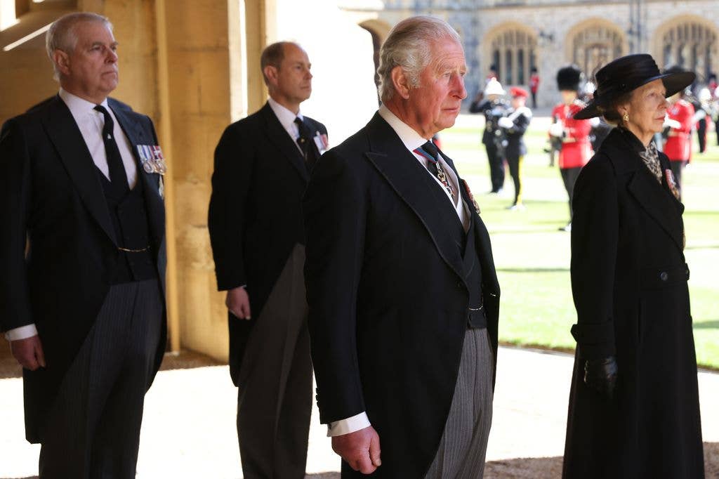 Prince Andrew, King Charles, and Prince Edward stand in formal attire at an event.