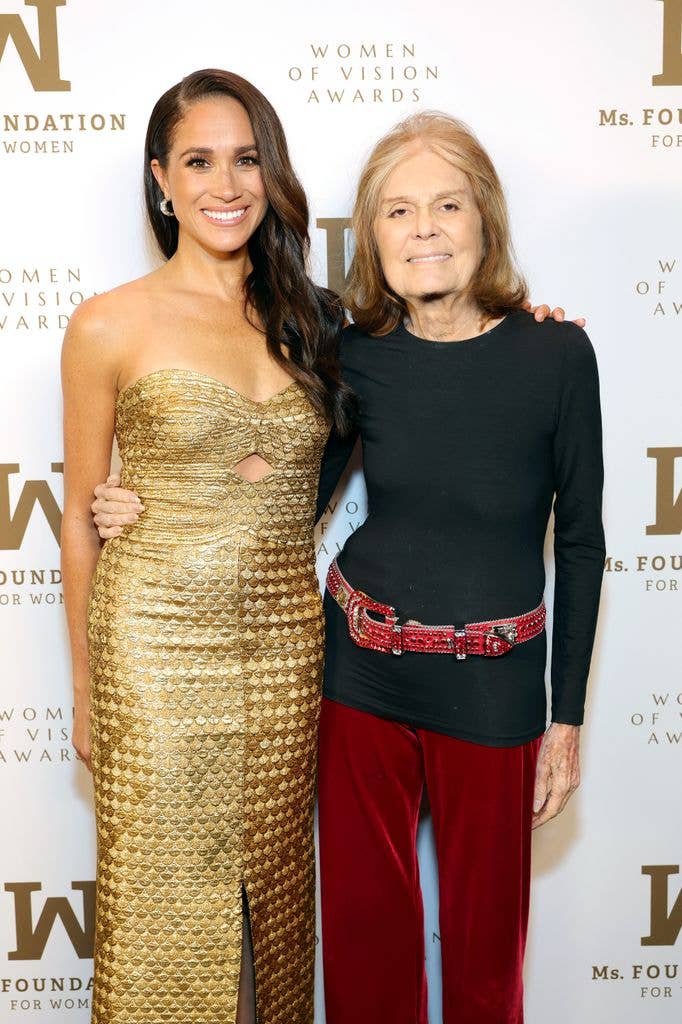 Meghan, Duchess of Sussex and Gloria Steinem smiling and posing together at an event.