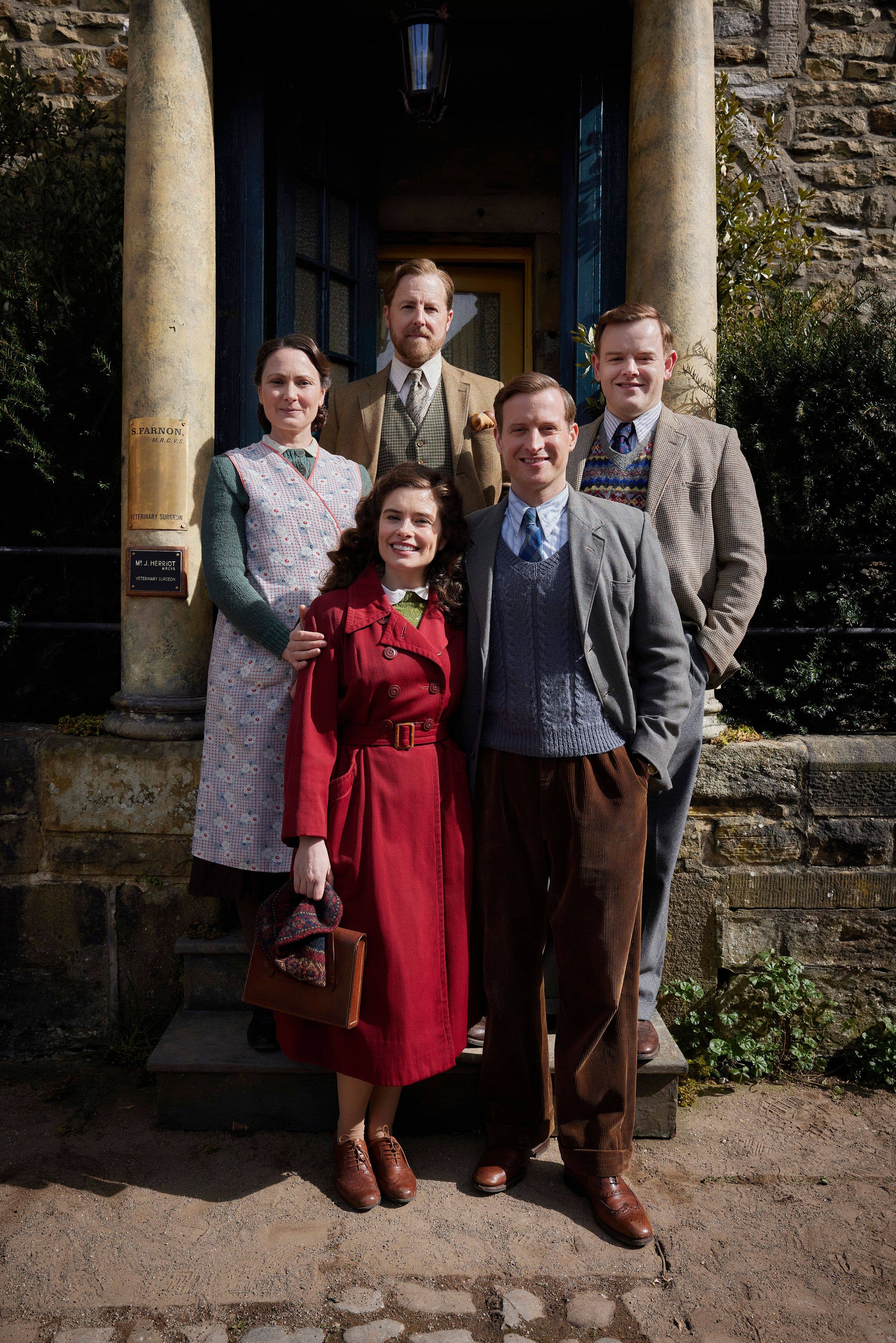 Samuel West, Rachel Shenton, and Anna Madeley among five people posing on steps in vintage attire.