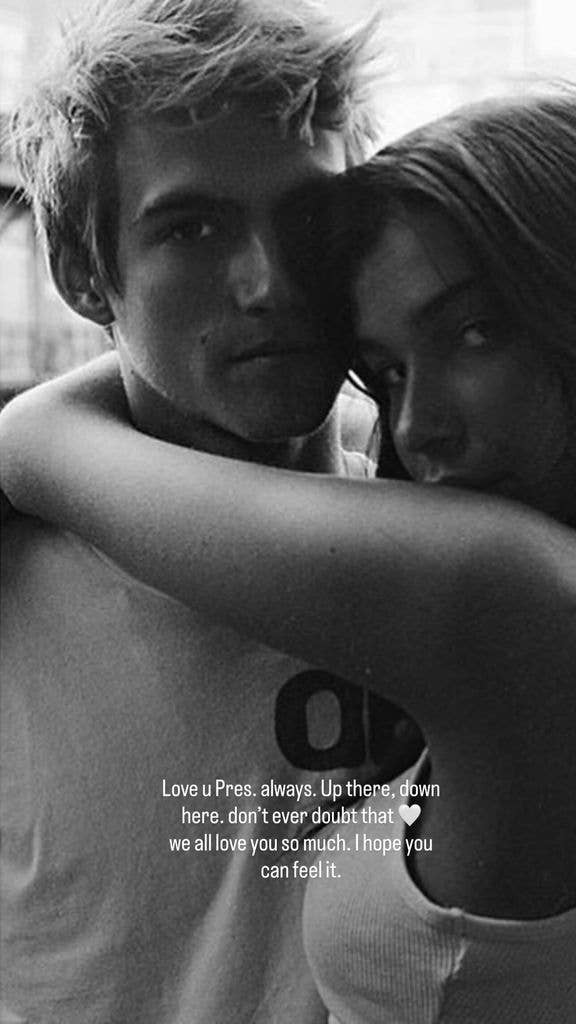 Presley Gerber starring into a camera while Charlotte D'Alessio wraps her arm around his neck