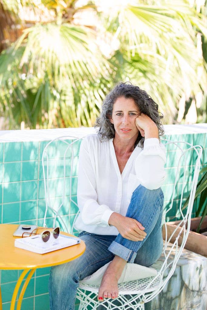 Woman sitting outside in white shirt