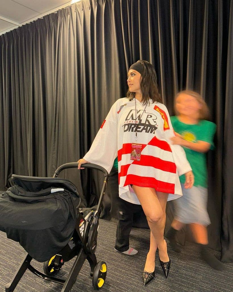 kourtney kardashian posing with rocky pram