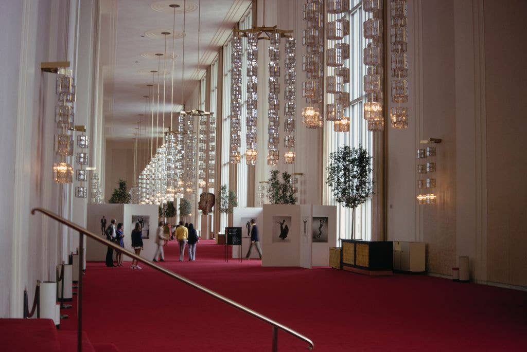 Visitors browsing a photography exhibition in the lobby of the Kennedy Center, Washington, DC, circa 1995. Formally the John F Kennedy Center for the Performing Arts, the cultural centre is on the eastern bank of the Potomac River in Washington, DC