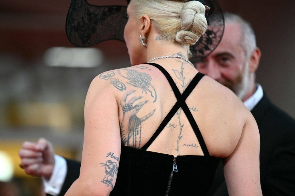A picture shows tattoos of actress and singer Lady Gaga as she attends the red carpet of the movie 'Joker : Folie a deux' presented in competition during the 81st International Venice Film Festival at Venice Lido, on September 4, 2024.