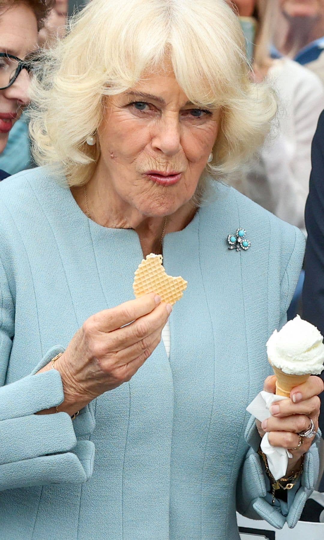 Queen Camilla holds a waffle and an ice cream cone.