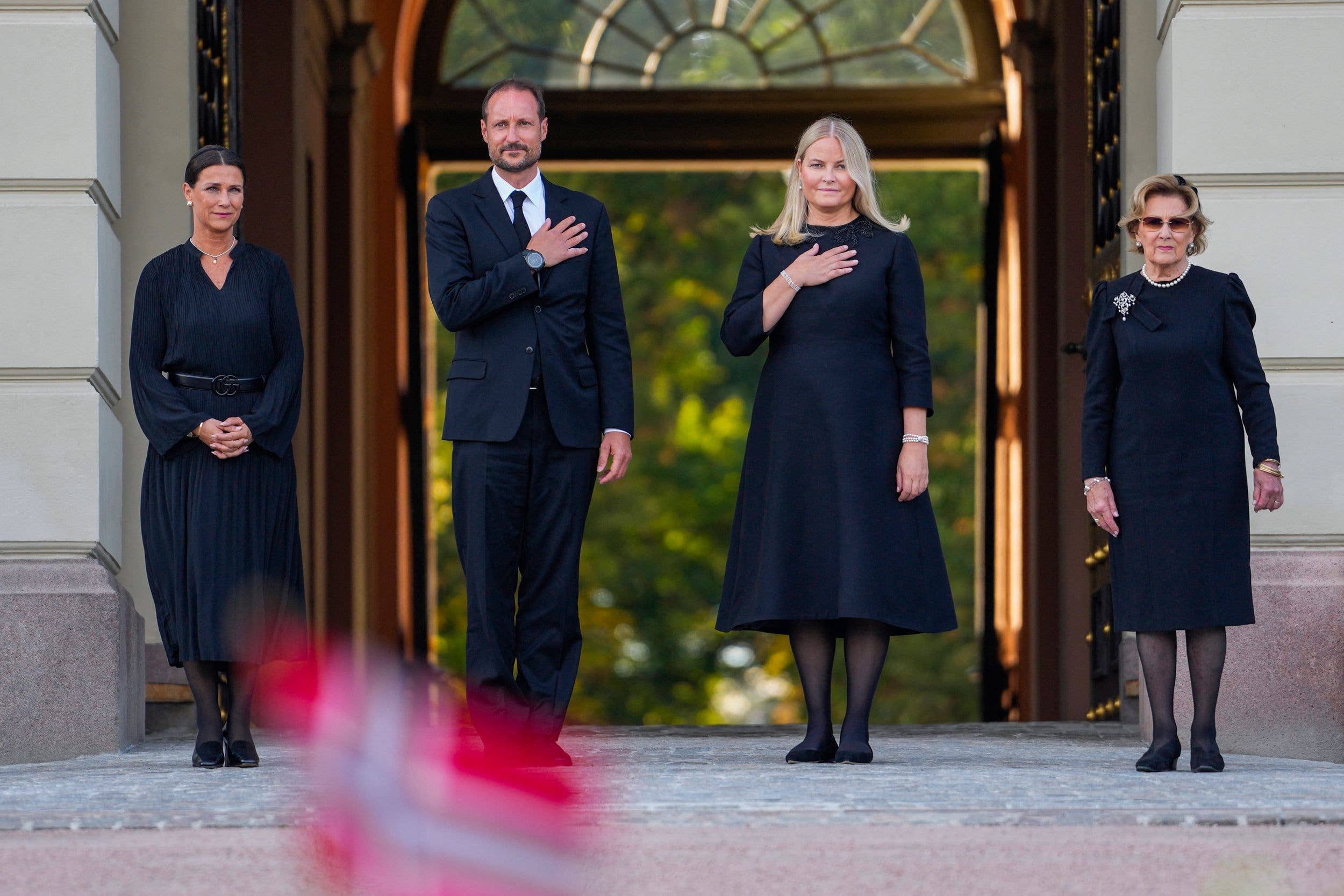 Princess Maertha Louise of Norway, King Haakon VIII of Norway, Queen Mette-Marit of Norway and Queen Sonja of Norway react as they arrive at the Palace Square to greet the crowd and look at the flowers and tributes that mourners have laid down in Oslo on August 31, 2026