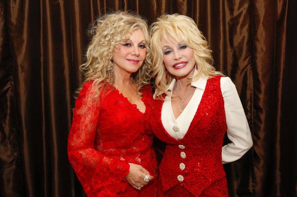Stella and Dolly Parton wearing red and smiling