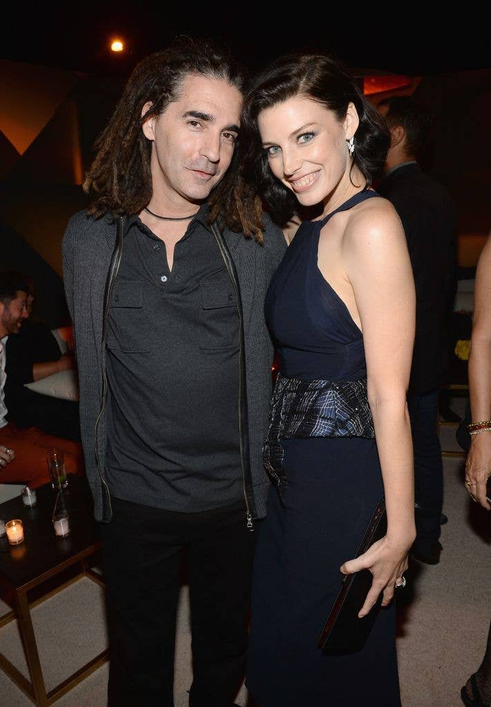 Jessica Paré stands next to John Kastner, both smiling at an event.