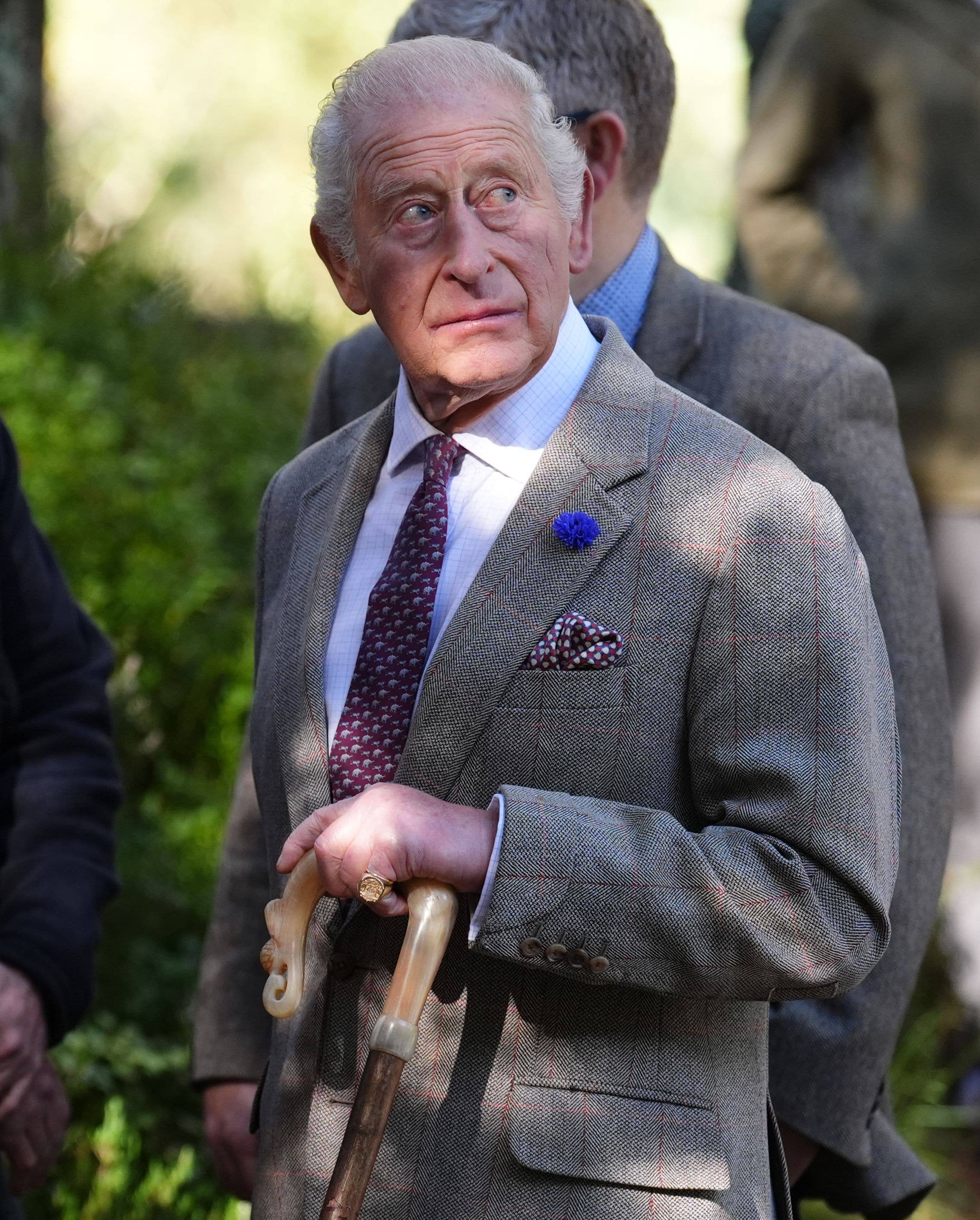King Charles using a walking stick in the highlands
