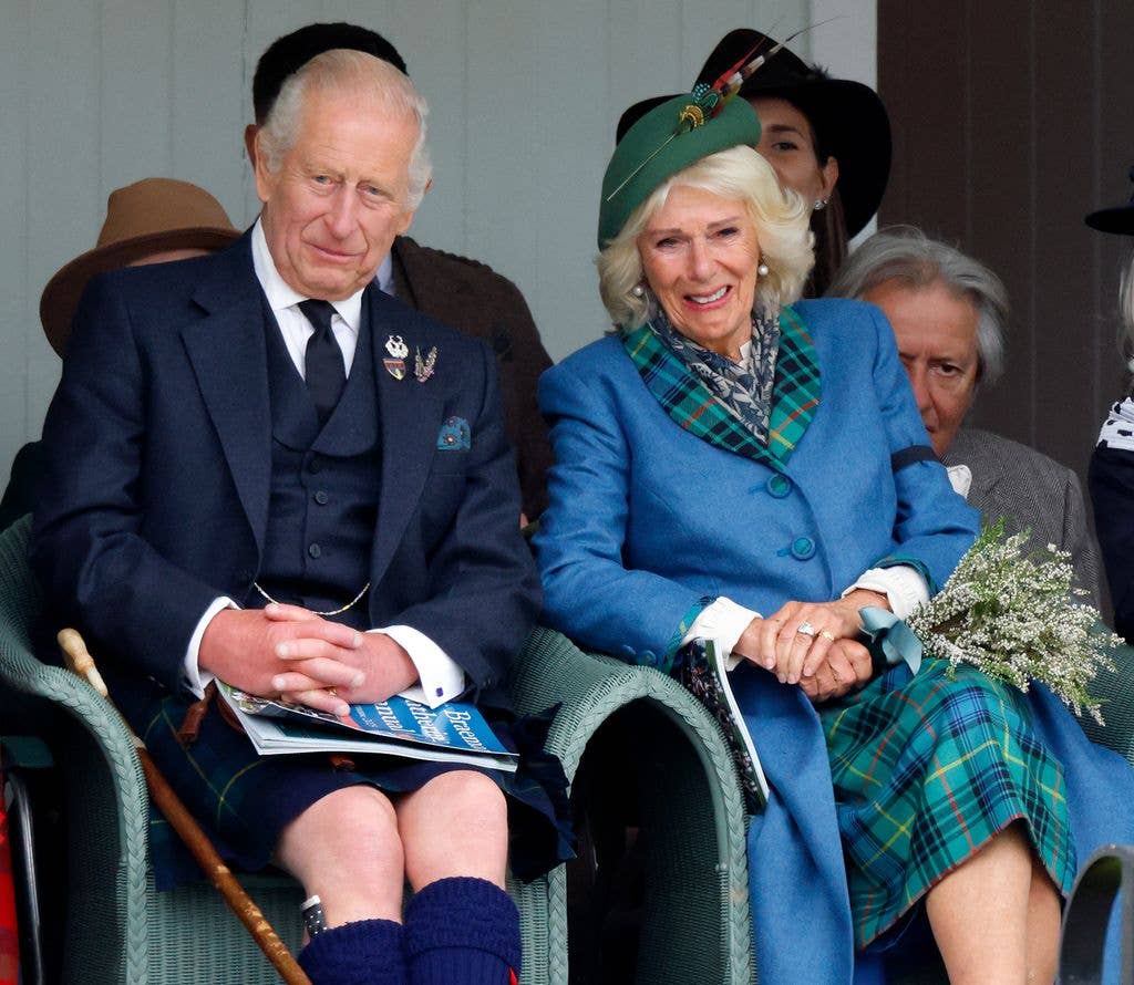 King Charles and Queen Camilla seated and smiling at an event