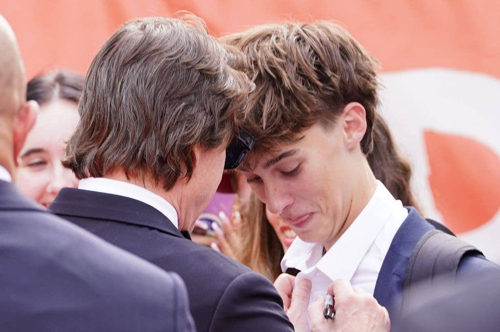 Tom Cruise signing a shirt whilst attending the Digger royal film performance and world premiere, at the Odeon Luxe in Leicester Square, central London. 