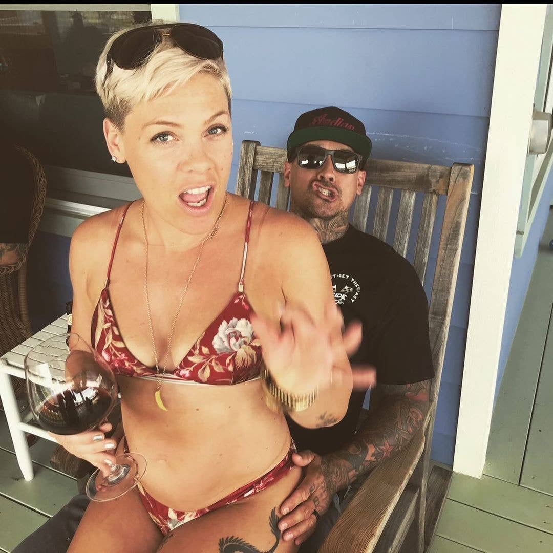 Pink photographed sitting on her husband Carey Hart's lap with a wine glass, shared on Instagram in 2024